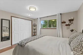Primary bedroom offers view to stunning back yard.
