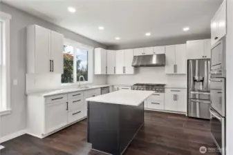 Slab quartz countertops, 3' x 6' island, subway tile backsplash and Pecan flooring make for a stylish kitchen!