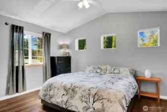 Primary suite with walk-in closet, new flooring, paint, ceiling fan and primary bath.