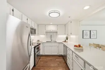 Updated kitchen with quartz countertops & stainless appliances. (Virtually Staged)