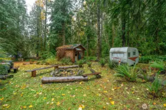 Bath house on grounds with vintage trailer