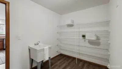 An exceptional walk-in pantry and laundry room offering impressive space, abundant storage, and thoughtful organization rarely found.