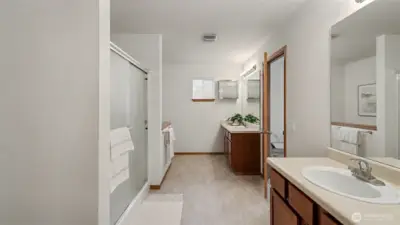 Bright and airy, this generous bath includes a separate shower and thoughtful layout, creating a spa-like sanctuary at home.