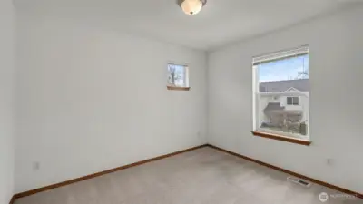 Bright and airy, this sunlit bedroom creates a cheerful and welcoming retreat.