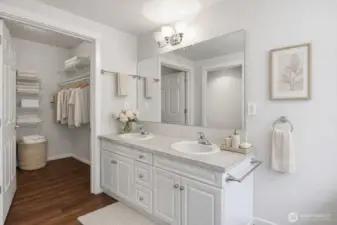 Primary bath has a double vanity and large walk-in closet.  This photo has been virtually staged.
