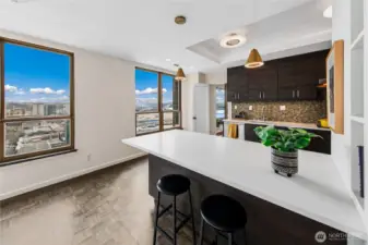 A broad peninsula offers casual seating while maintaining visual connection to the surrounding cityscape.