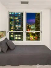 City lights lend a quiet presence to the room as evening settles across downtown.