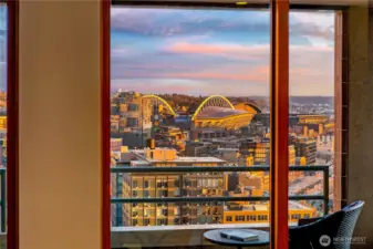 From the penthouse living room, the southern skyline extends toward the stadium district and Mount Rainier beyond.