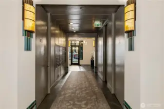 A quiet residential corridor leads to the upper levels where the penthouse is located.