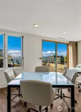 A community gathering room provides expansive outlooks across Elliott Bay and the skyline.