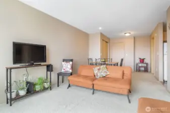 Open-layout living room flowing into dining area and hallway