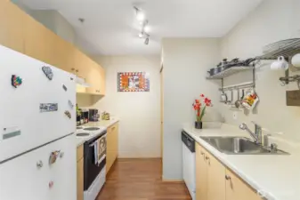 Well-equipped kitchen with stainless sink, ample counter space, and upper cabinets