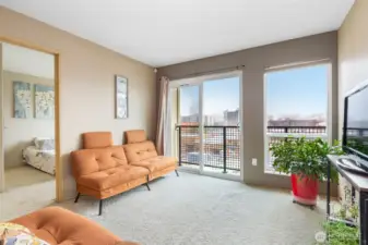 The living room flows into the bedroom with mountain and city views.