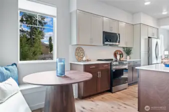 The 1626 plan includes built in corner seating bench.    Photos is of community model home.