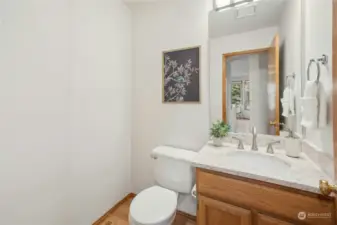 The main level powder room features a quartz countertop and updated lighting.