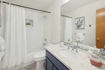 Recent updates enhance this home, including a beautifully remodeled upper-level bathroom with custom tile tub/shower, a heated floor and quartz vanity.