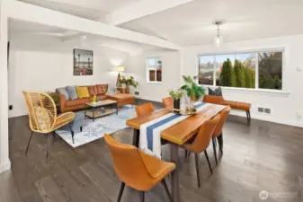 Living and dining space eastern facing with large windows and vaulted ceilings