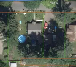 The subject vacant land includes the driveway, as pictured here. House and pool are on the original lot that is not for sale.