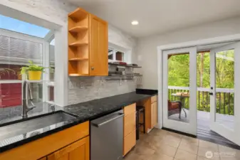 French doors flow from the kitchen to a spacious Trex deck, ideal for BBQs, lounging, or catching the sunset over the backyard.