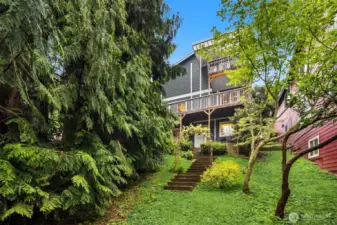 Step through a vine-covered archway into your private outdoor paradise. This 7,827 sq ft space offers unparalleled privacy and a garden-like, whimsical atmosphere.