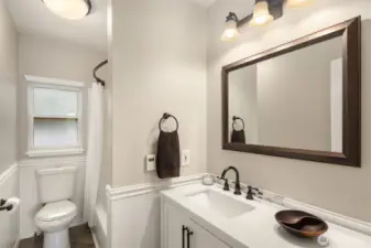 Primary suite bathroom featuring exquisite wainscoting.