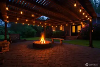 Evening view of the pergola with firepit and lights.