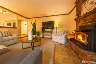 Cozy family room with woodburning fireplace/stove.