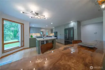 The wood you see in the foreground is a polished maple slab seats 4+ easily and overlooks the family room from the kitchen side.   You must see it to appreciate it!