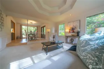 View from the living room to the dining room. Notice the wainscoting and the coffered ceiling adds depth and architectural interest to a room.