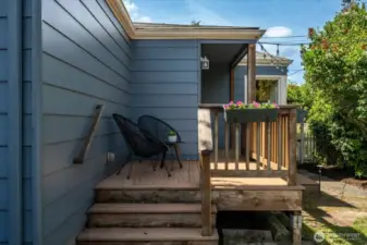 The back porch enhanced with built-in planters, adding greenery and inviting nature right to your doorstep.