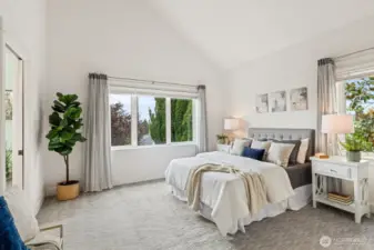 Stately primary suite with vaulted ceilings.