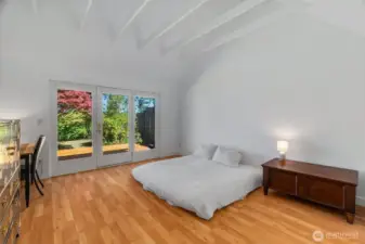 primary room w doors to back yard deck & views