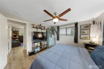 Spacious main bedroom with a modern ceiling fan and integrated light.