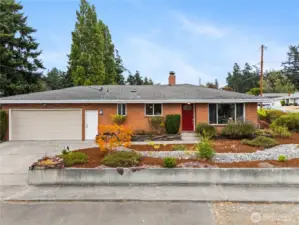 Move in ready look with a brick exterior, bright picture windows, and low maintenance plantings.