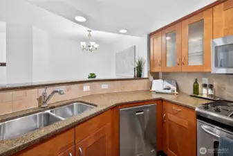Kitchen includes bar which overlooks dining area