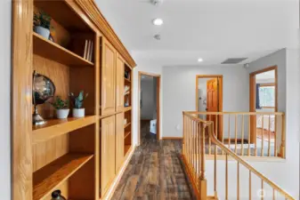 Custom shelving and storage leading to the two additional bedrooms and bathroom.