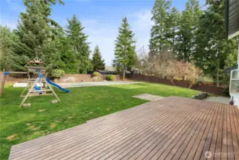 This yard has it all! A large deck for hosting, a hot tab pad (plumbed and wired) for relaxation and a sport court for fun!