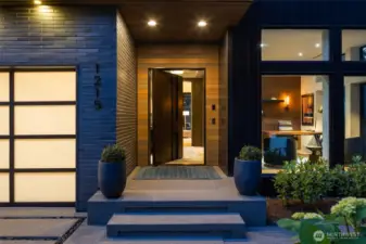 Welcoming entry porch with solid mahogany pivot door.