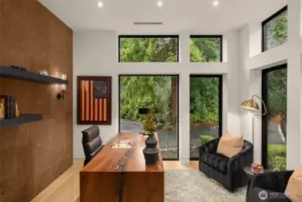 Main level office/den space with leather paneled wall.