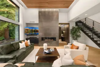 Open great room design flooded with natural light. Walnut wood ceiling paneling.