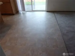 Eating area with slider to fenced back yard and patio.