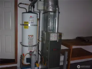 Forced air gas furnace and gas water heater in garage.