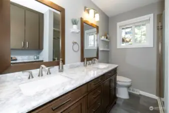 Main Level Bath has double sinks and plenty of storage space for linens and toiletries.
