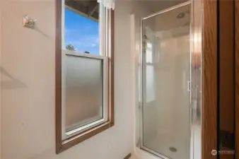 Primary shower is private with a pocket door and commode on the other side~