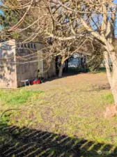 Fenced back yard with storage shed.