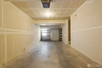Two car tandem garage with lots of storage space and rear patio exit
