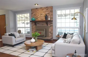 This is an virtually staged view in to the living room with hand scraped style wood flooring and a wood burning stove to provide peace of mind in emergencies.  This home blends functionality with location—what an opportunity!