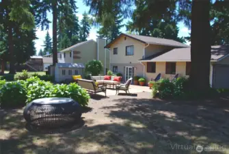 Virtually stage backyard view of this 1,659 sqft, 3 bed, 2.5 bath, tri-level, all nestled on a large corner lot in south hill Puyallup. Patio off family room is great for outdoor entertaining, BBQs, or simply relaxing. Plenty of backyard space for an RV and backyard fun, includes shed.