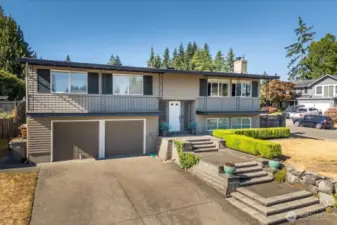 Artful and pristine landscaping greets you every time you pull into the driveway.