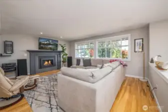 A spacious living room and cozy fireplace welcome you as you reach the top of the stairs.